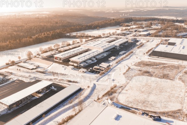 Industrial area in a wintry landscape with factory buildings, forests and snow-covered fields, Nagold, Calw district, Black Forest, Germany