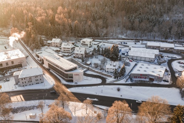 Snowy buildings and roads in an industrial and residential area during winter, Nagold, Calw district, Black Forest, Germany