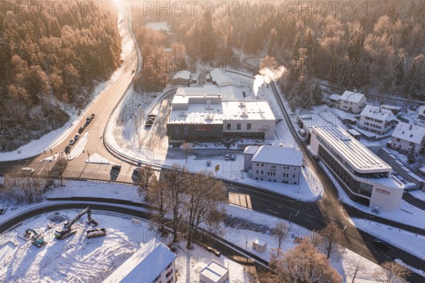 Snowy factories and roads near a forest area in winter time, Nagold, Calw district, Black Forest, Germany