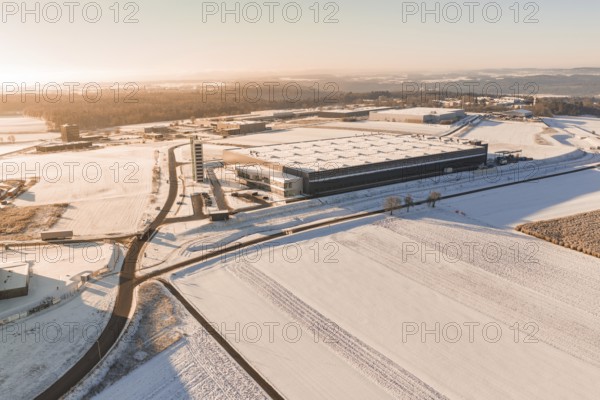 Large industrial site in snow-covered landscape under bright skies, Nagold, Calw district, Black Forest, Germany