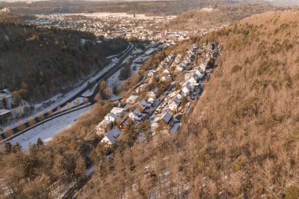 Snowy winter landscape of a village on the edge of a hill, surrounded by forest, Nagold, Calw district, Black Forest, Germany