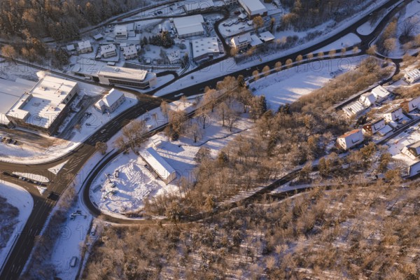 Bird's eye view of a snowy winter landscape with roads, buildings and forests, Nagold, Calw district, Black Forest, Germany