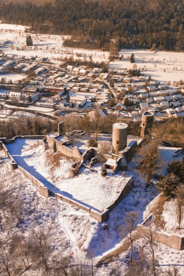 A snowy castle with medieval towers looking over a village of small houses, Nagold, Calw district, Black Forest, Germany