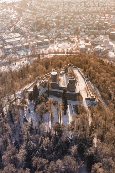 Snowy castle surrounded by trees and city, bird's-eye view of winter atmosphere, Nagold, Calw district, Black Forest, Germany