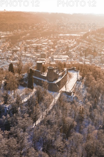 Bird's-eye view of snowy castle surrounded by forest and city, Nagold, Calw district, Black Forest, Germany