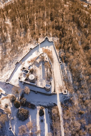 Aerial view of a snowy castle with a triangular layout surrounded by trees, Nagold, Calw district, Black Forest, Germany