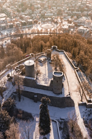 Snowy castle with two towers and city in the background, wintery atmosphere, Nagold, Calw district, Black Forest, Germany