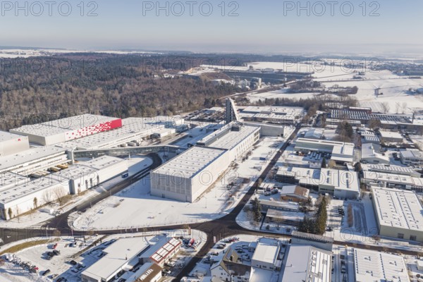 Aerial view of a snowy industrial area with factory buildings and adjacent forest, Nagold, Calw district, Black Forest, Germany