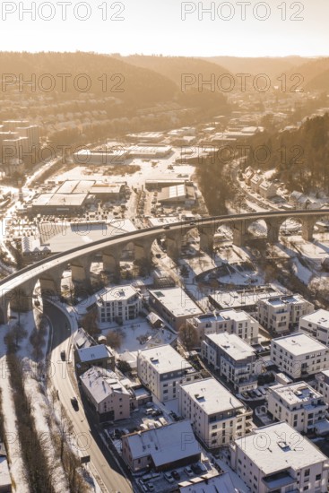 Viaduct over snow-covered residential areas in a city, with hills in the background, Nagold, Calw district, Black Forest, Germany
