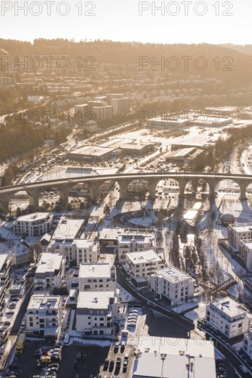 Aerial view of a viaduct over a snowy town surrounded by hills in morning light, Nagold, Calw district, Black Forest, Germany