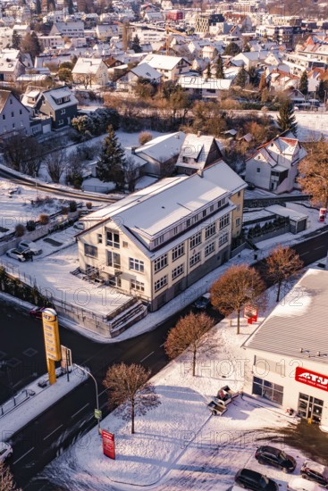 Building at a snowy crossroads in a town, Nagold, Calw district, Black Forest, Germany