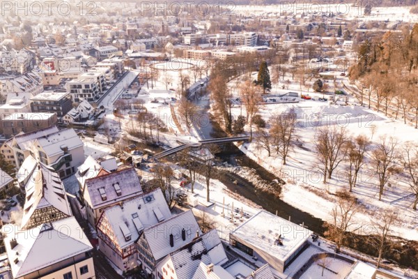 Snowy town with a river and a bridge, surrounded by trees and houses, Nagold, Calw district, Black Forest, Germany