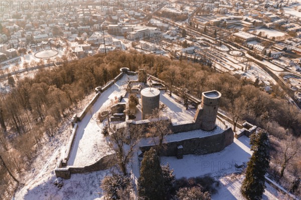 Snowy castle from a bird's eye view, surrounded by city and forest landscape, Nagold, Calw district, Black Forest, Germany