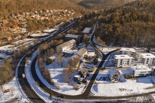 Snowy bird's-eye view of city with buildings and curved road, Nagold, Calw district, Black Forest, Germany