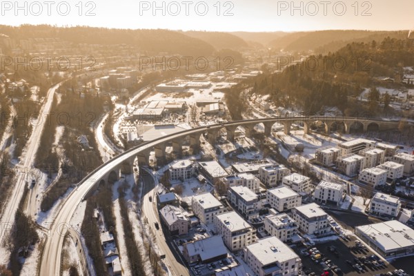 Aerial view of a viaduct and snowy cityscape surrounded by hills and roads, Nagold, Calw district, Black Forest, Germany