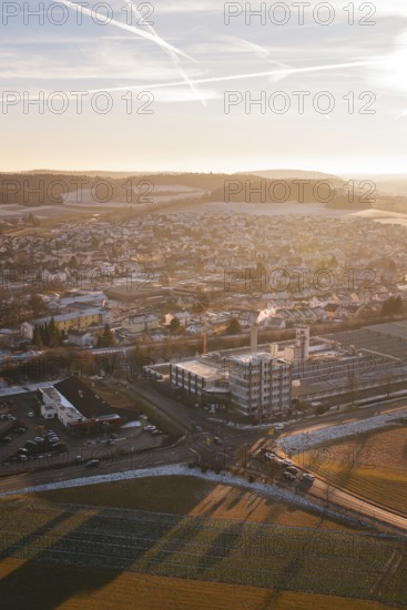 Urban panorama at sunset, pastel colors in the sky, surrounded by fields and snow-covered areas, Althengstett, Calw district, Germany