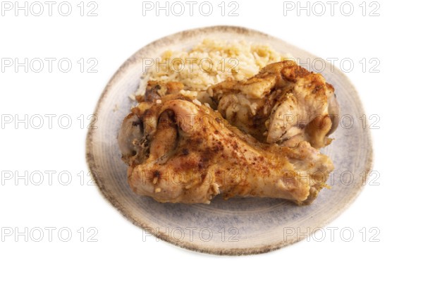 Fried Turkey Wing with spices and rice on plate isolated on white background. side view, close up