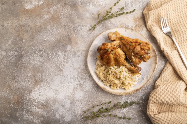 Fried Turkey Wing with spices and rice on brown concrete background and linen textile. top view, flat lay, copy space