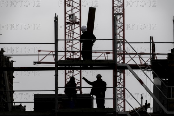Construction site, scaffolding work on a large construction project, apartments and commercial premises, symbolic image of the construction industry