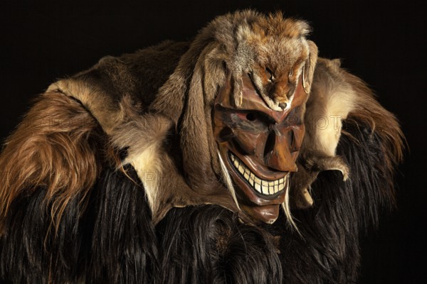 Portrait of traditional hand-carved wooden mask from the Loetschental Carnival, representing folkloric characters, spirits, and demons, Loetschental village, Valais Canton, Switzerland