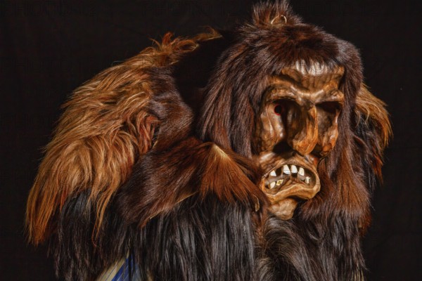Portrait of traditional hand-carved wooden mask from the Loetschental Carnival, representing folkloric characters, spirits, and demons, Loetschental village, Valais Canton, Switzerland