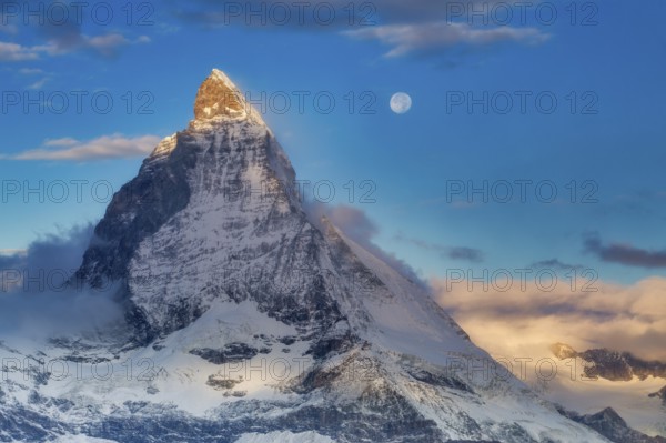 Sunrise with the moon over the Matterhorn (4, 478 m), one of the world's most iconic mountains, Pennine Alps, Zermatt, Valais Canton, Switzerland