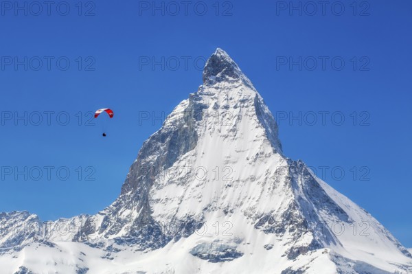 Winter paragliding near the Matterhorn, Zermatt, Valais, Switzerland
