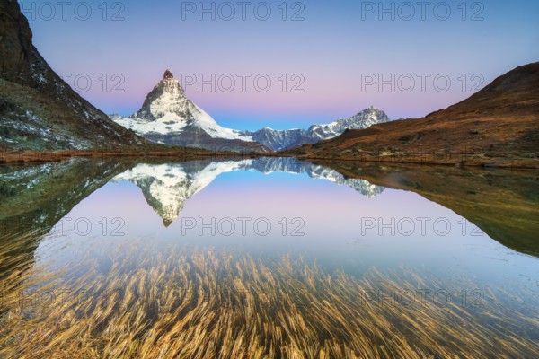 Matterhorn at 4, 478?m, iconic symbol of Switzerland, reflected in Riffelsee Lake at sunrise in autumn, Zermatt, Valais, Switzerland
