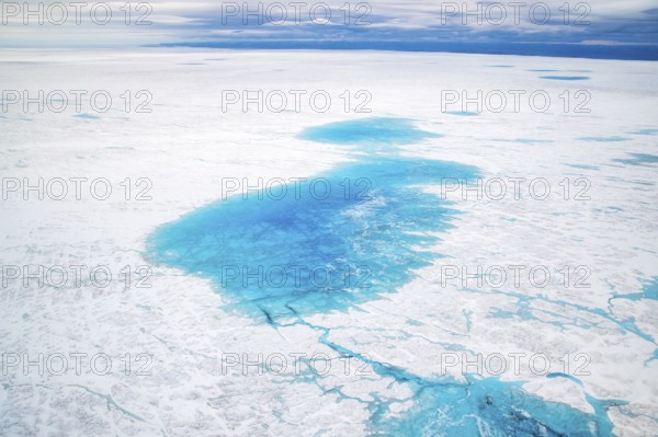 Surface meltwater lakes on the Greenland Ice Sheet, visible impact of climate change, Aerial view, Arctic, Greenland, Geographically in North America, politically part of the Kingdom of Denmark