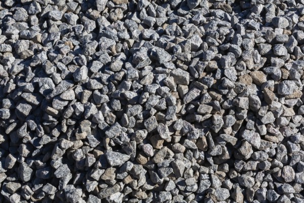 Close-up of grey crushed stone aggregate used to form a bed for constructing roads and driveways on, Quebec, Canada