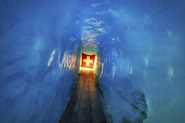 Ice cave, Swiss flag in the ice cave, Tourists attraction, Rhone glacier, Furka pass, Obergoms, Canton Valais, Switzerland