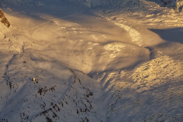 Sunset at Monte Rosa Hut (2, 883?m), alpine refuge in the Pennine Alps on the Italy–Switzerland border, starting point for freeride skiing, ski mountaineering, and mountain adventures, Valais, Switzerland