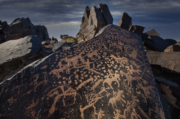 Ancient rock carvings of animals and human figures, depicting a hunting scene, dating from the Neolithic and Bronze Age (c. 4000–1000?BCE), Mandela Mountains, Alxa Right Banner (Alxa Youqi), Inner Mongolia, near the Badain Jaran Desert, China, Asia