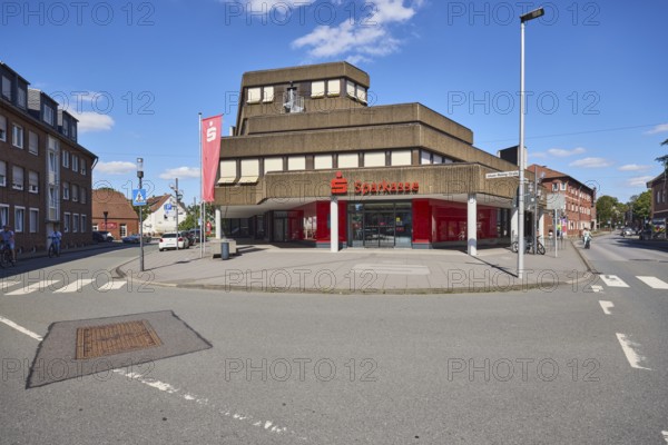 Sparkasse Westmünsterland, headquarters, commercial building, concrete architecture, modern architecture, general development, advertising flags on flagpoles, lantern, sidewalk, street, pedestrian crossing, zebra crossing, blue sky, cumulus clouds, Brinkstraße, Johann-Walling-Straße and Blumenstraße intersection, Borken, Münsterland, Borken district, North Rhine-Westphalia, Germany