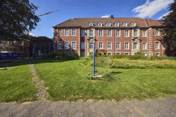 Town Hall, historic brick building, façade with windows, dormers, building sign, sidewalk, meadow, trees, blue sky, cumulus clouds, Im Piepershagen, Borken, Münsterland, Borken district, North Rhine-Westphalia, Germany