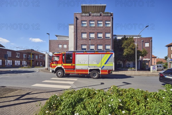 Fire truck, fire department city of Borken, general architecture, commercial building, modern architecture, lantern, pedestrian crossing, zebra crossing, street, flower bed, blue sky, cumulus clouds, Brinkstraße, Borken, Münsterland, Borken district, North Rhine-Westphalia, Germany