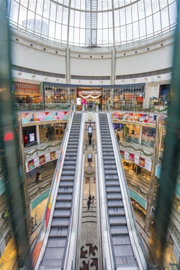 Symmetrical escalators in a spacious and bright shopping center, London, England, Great Britain