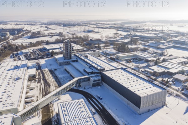 Large aerial view of snowy industrial complex under clear sky showing modern architecture, Häfele, Nagold, Germany