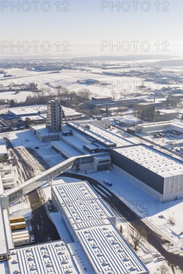 Aerial view of a snowy industrial area with several modern buildings on a clear winter day, Häfele, Nagold, Germany