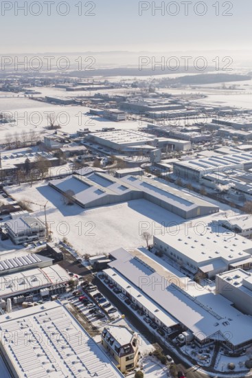 Snow-covered industrial area with a variety of buildings under clear skies, Wolfsberg industrial area, Nagold, Germany