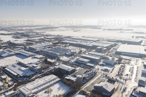 Aerial view of an industrial area in winter with snowy roofs and clear sky, Wolfsberg industrial area, Nagold, Germany