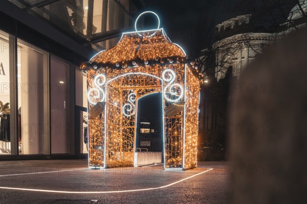 Brightly lit pavilion with festive Christmas decoration at night, London, England, Great Britain