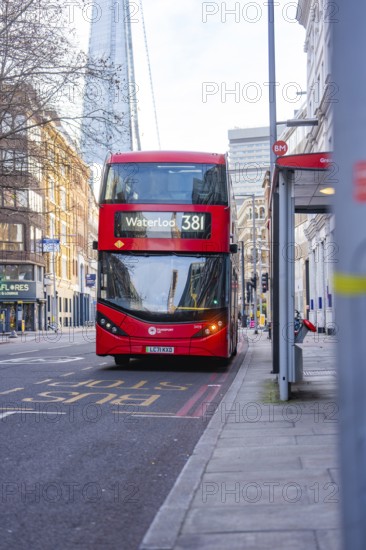 A red double-decker bus travels through the streets of London, London, England, Great Britain