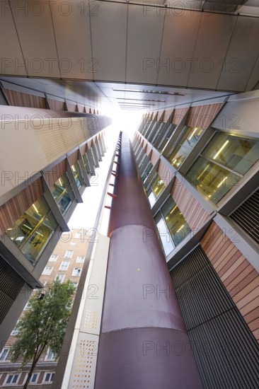 A symmetrical upward look between two modern buildings, London, England, Great Britain