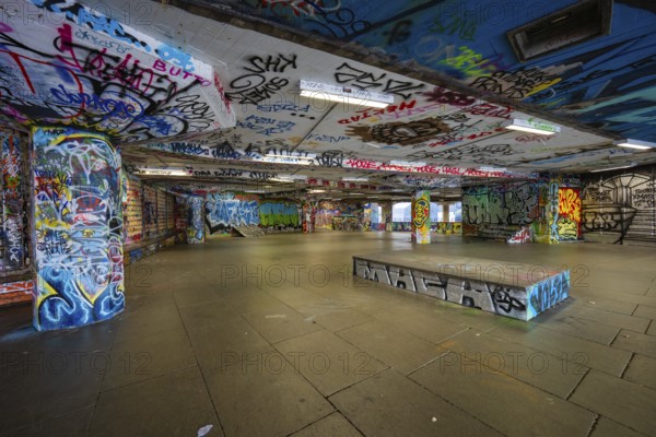 Colourful graffiti covering an underpass in an urban setting, London, England, Great Britain