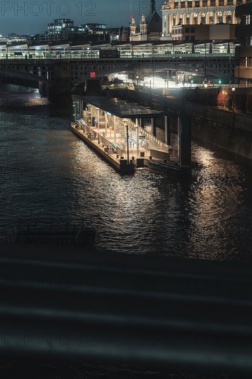 Nocturnal river landscape with illuminated bridges and buildings in the city, London, England, Great Britain