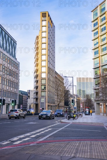 An urban street scene with modern buildings and moving cars, London, England, Great Britain