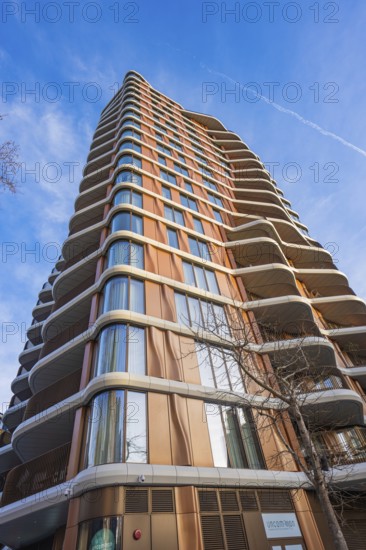 A modern high-rise building stretches against the blue sky, London, England, Great Britain