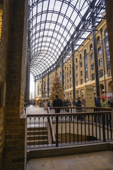 A shopping mall interior with a big Christmas tree and lots of people, London, United Kingdom