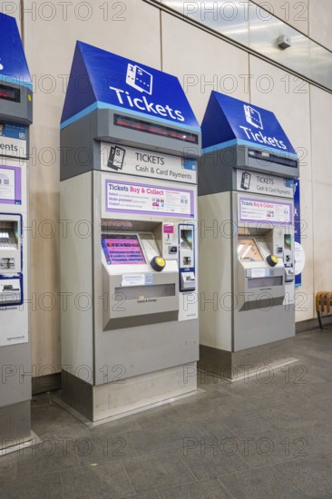 Row of blue and silver ticket machines in a train station, London, United Kingdom